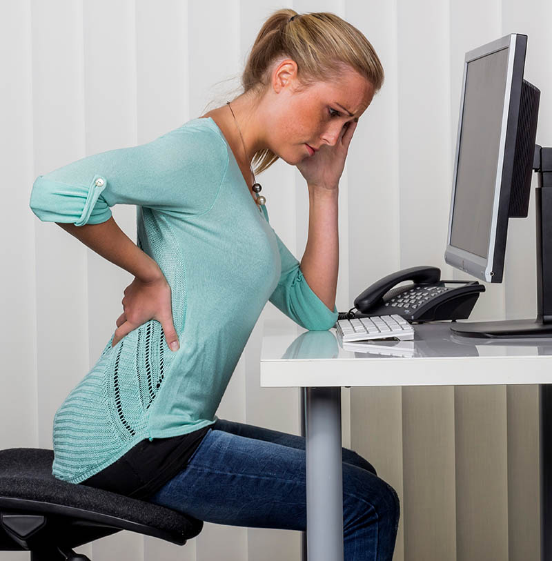 Woman with low backache in the office